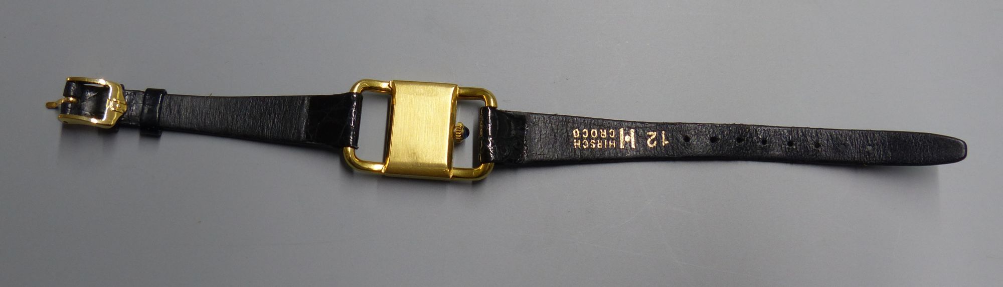 A ladys 18ct gold Kutchinsky manual wind rectangular dial wrist watch, with Ebel movement, on associated leather strap,